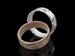Klastys Ring in 18k white and rose gold — crackle-patterned band inspired by Ginnungagap, the Norse primordial void where the world was born.
